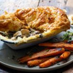 Chicken & Mushroom Pie served on a plate with carrots on the side