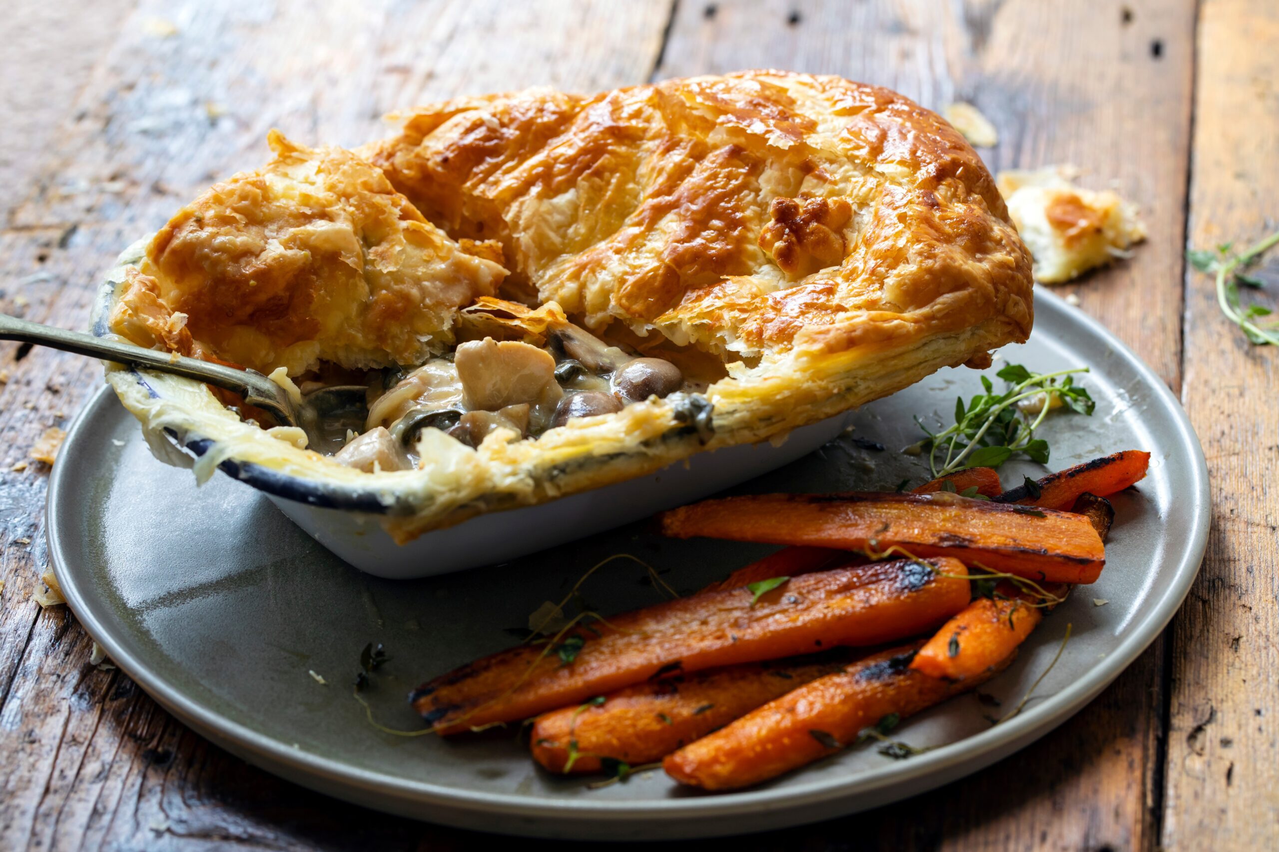 Chicken & Mushroom Pie served on a plate with carrots on the side