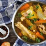 Chicken Long Soup served in a bowl with a bowl of whole peppercorn for decoration