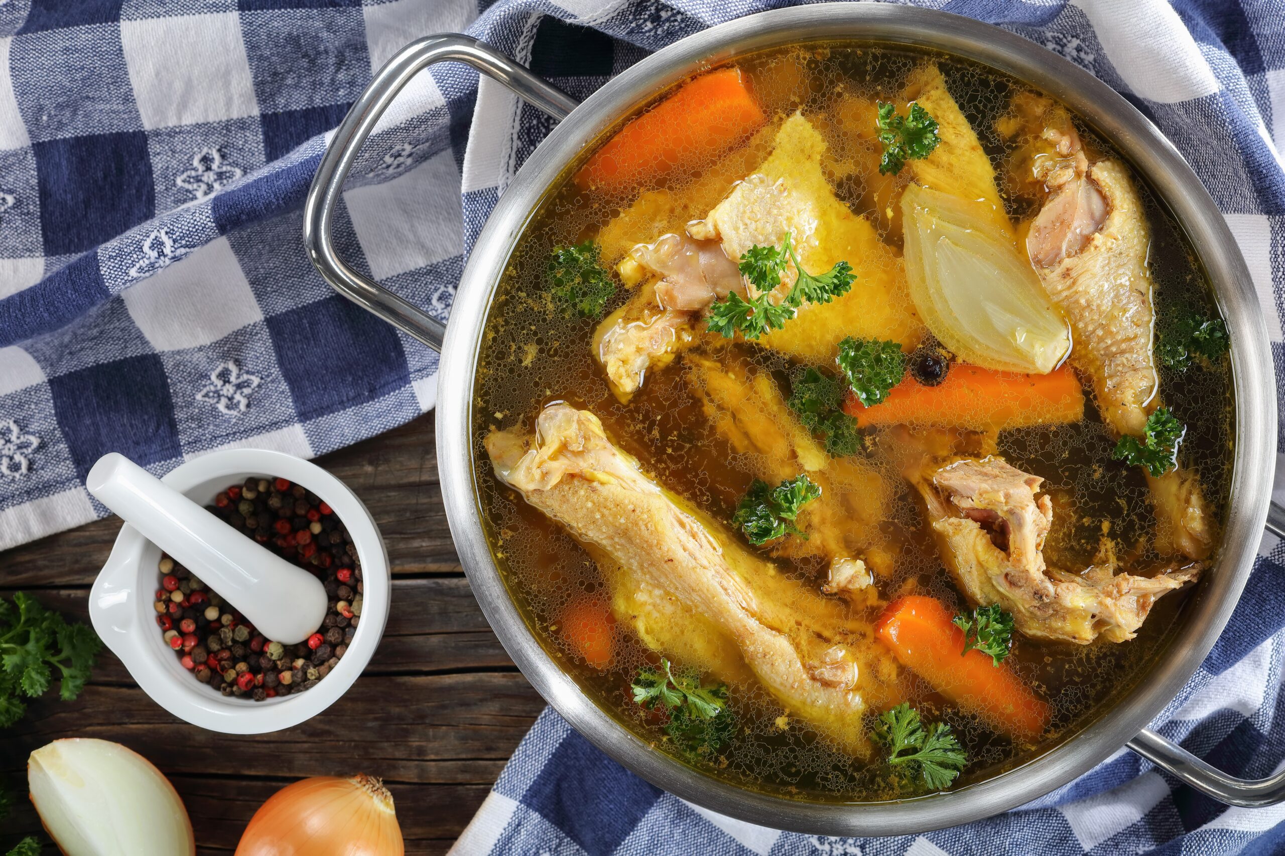 Chicken Long Soup served in a bowl with a bowl of whole peppercorn for decoration