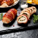 Chicken Stuffed with Cream Cheese served on a slate board