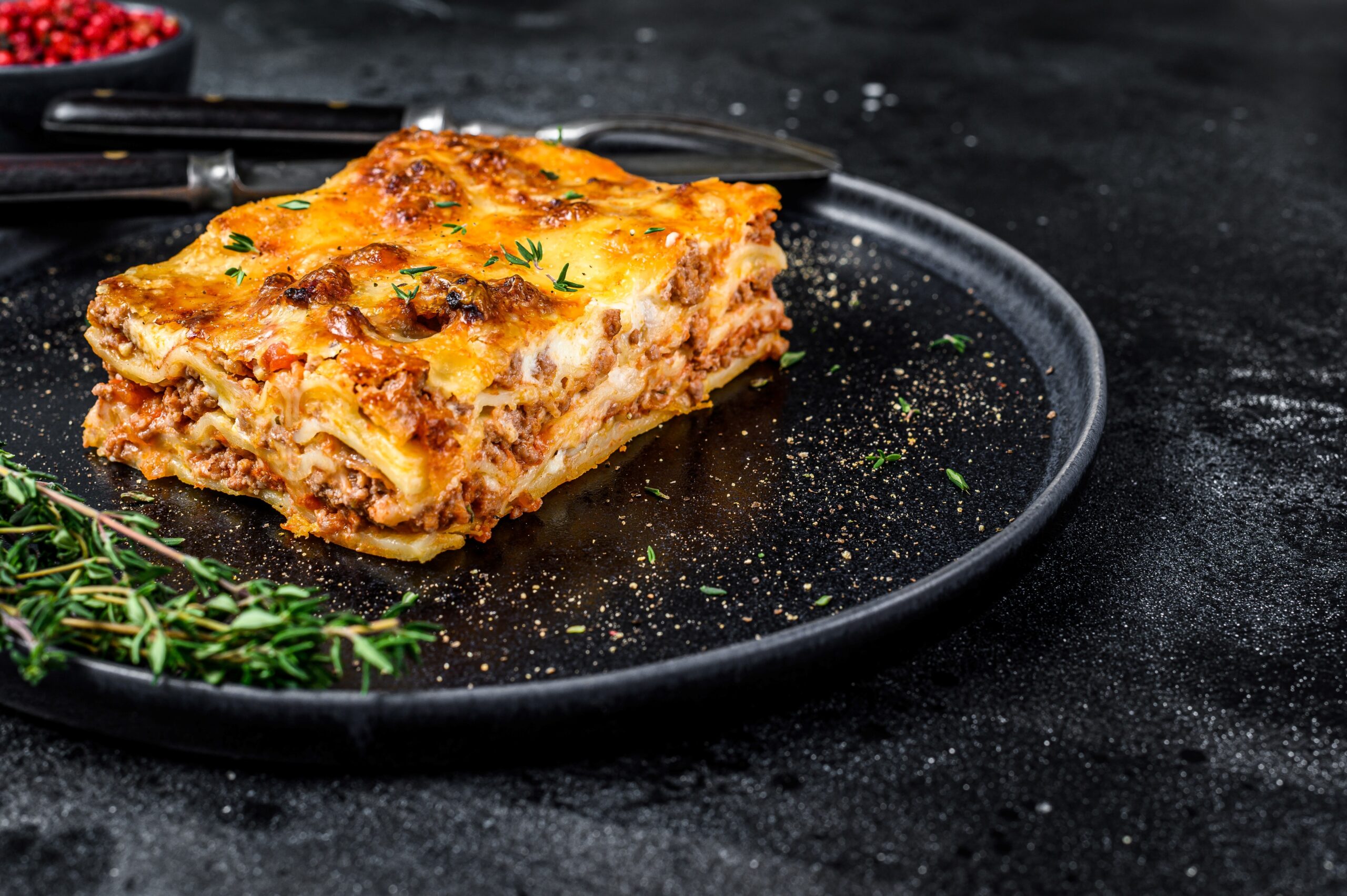 Four Cheese Lasagne served on a black plate