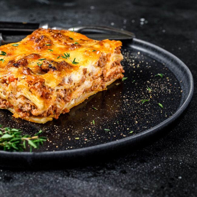 Lasagne served on a black plate