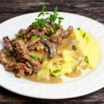 Pork Stroganoff served on a white plate