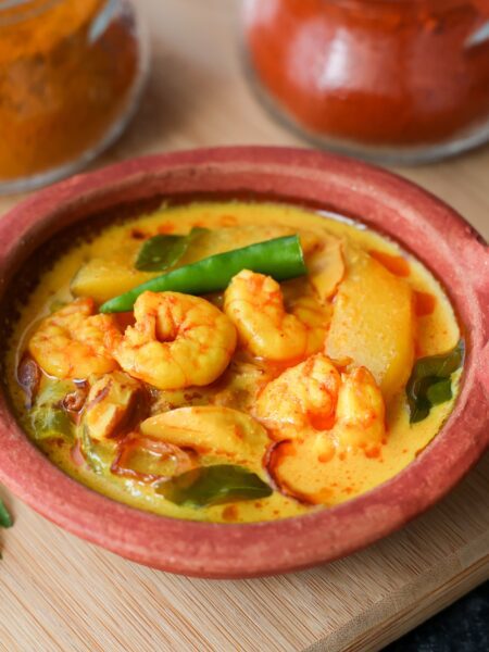 Red Thai Prawn and Mango Curry served in a terracotta bowl