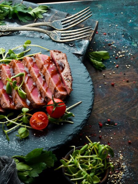 Pan-seared Tuna steak served on a blue plate